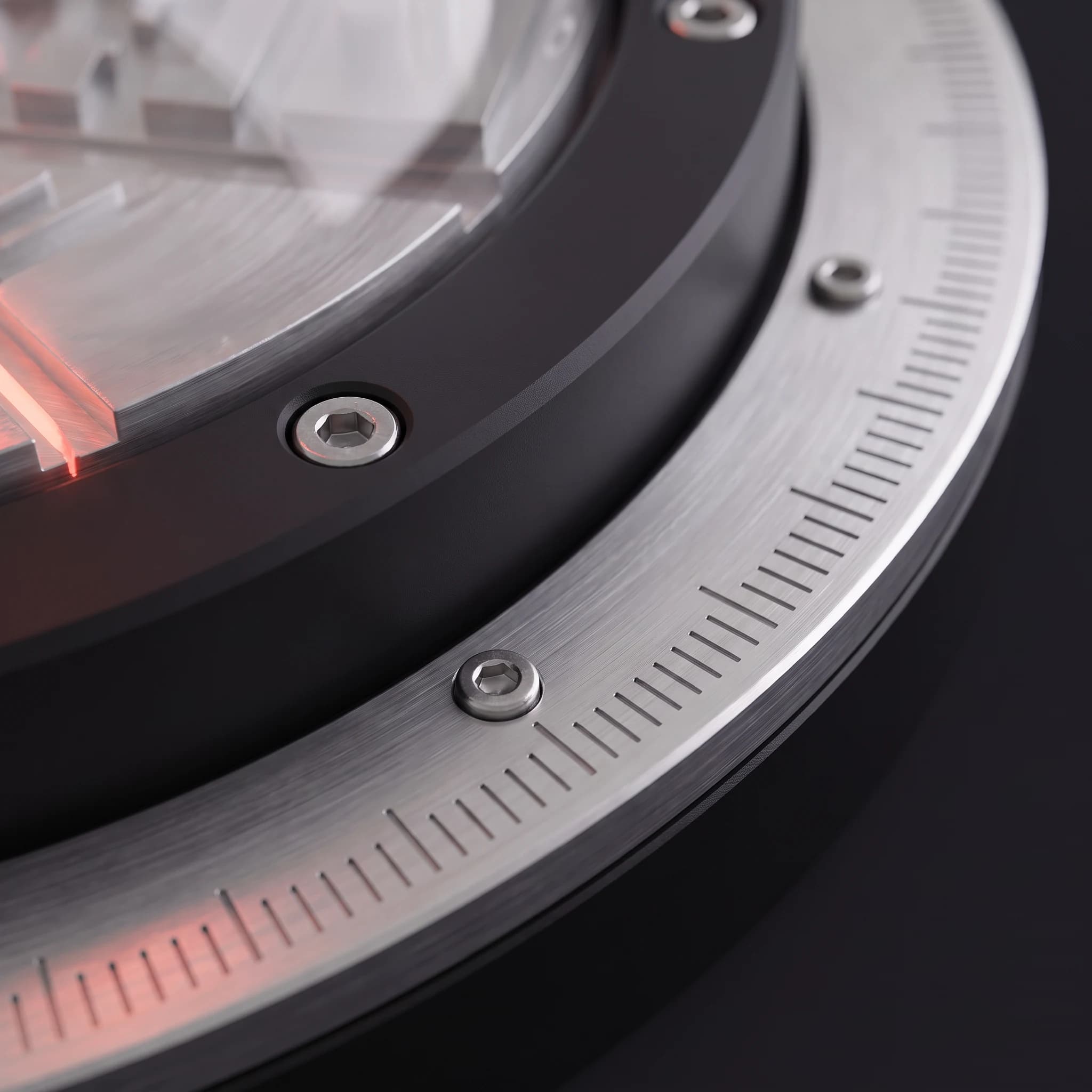 Macro view along the brushed aluminium graduation ring at the instrument's rim, engraved tick marks and a hex fastener in sharp focus, a coral reflection caught on the edge